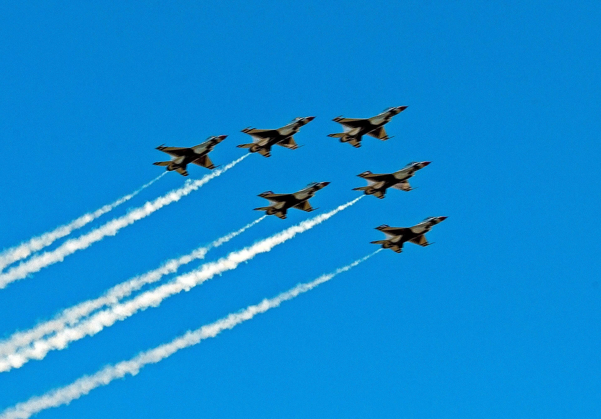 Jet demonstration team in close diamond formation overhead at an air show